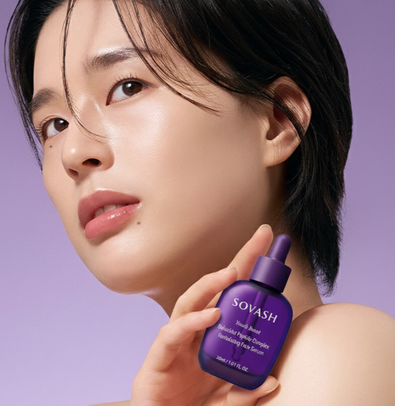 Woman holding a purple Sovash skincare bottle against a light purple background